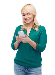 Image showing happy woman with smartphone texting message