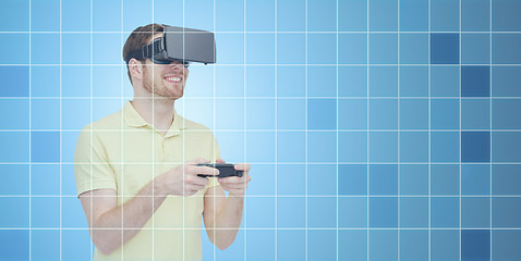 Image showing happy man in virtual reality headset with gamepad