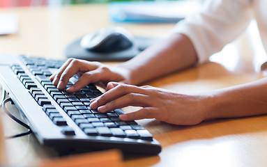 Image showing close up of female hands typing on keyboard