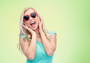 Image showing happy young woman in heart shape sunglasses