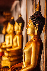 Image showing Gold sitting Buddha statues in Thailand