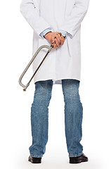 Image showing Crazy doctor is holding a big saw in his hands