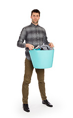 Image showing Full length portrait of a young man holding a laundry basket