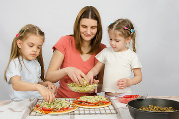 Image showing Mom with two young assistants make pizza