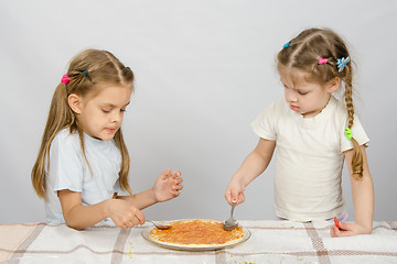 Image showing Two little sisters concentrated smear sauce based pizza