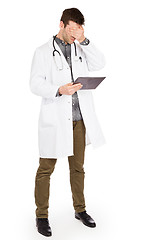 Image showing Male Caucasian doctor holding a digital tablet, looking shocked