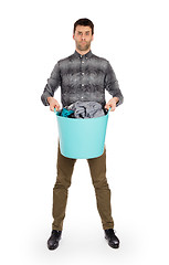 Image showing Full length portrait of a young man holding a laundry basket