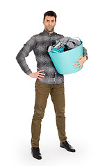 Image showing Full length portrait of a young man holding a laundry basket