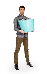 Image showing Full length portrait of a young man holding a laundry basket