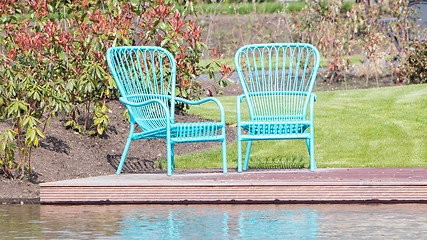 Image showing Two blue chairs at the waterfront