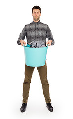 Image showing Full length portrait of a young man holding a laundry basket