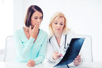 Image showing doctor with patient looking at x-ray