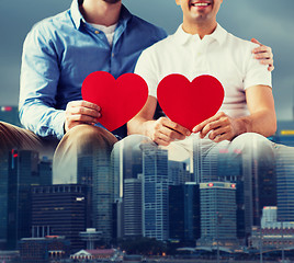 Image showing close up of happy gay male couple with red hearts