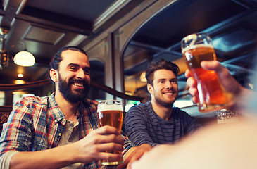 Image showing happy male friends drinking beer at bar or pub