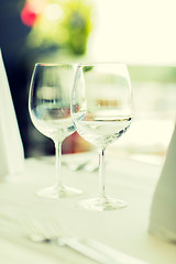 Image showing close up of two wine glasses on restaurant table