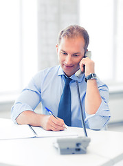 Image showing handsome businessman talking on the phone