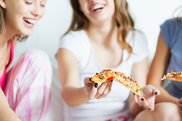 Image showing happy friends or teen girls eating pizza at home