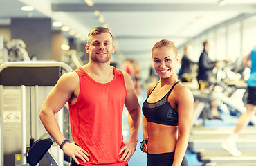 Image showing smiling man and woman in gym