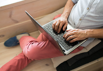 Image showing close up of creative man with laptop at office