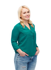 Image showing smiling young woman in shirt and jeans