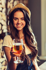 Image showing happy young woman drinking water at bar or pub