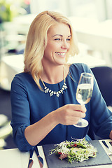 Image showing happy woman drinking champagne at restaurant