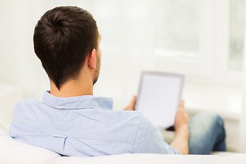 Image showing close up of man working with tablet pc at home