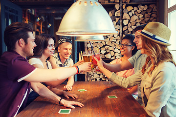 Image showing happy friends drinking beer at bar or pub