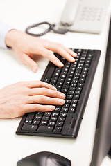 Image showing close up of businessman hands typing on keyboard