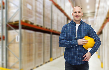 Image showing happy man with hardhat over warehouse