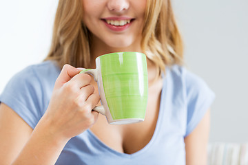 Image showing happy woman or teen girl drinking tea from cup