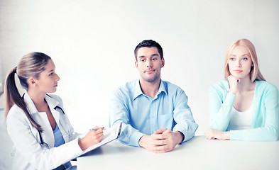 Image showing doctor with patients in cabinet