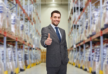 Image showing happy man at warehouse showing thumbs up gesture