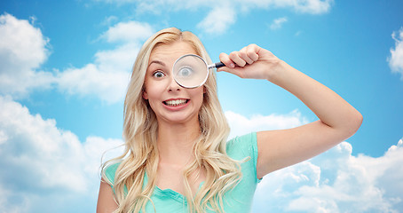 Image showing happy young woman with magnifying glass