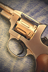 Image showing old revolver on blue jeans