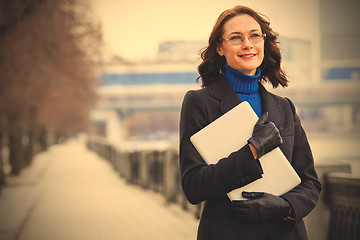 Image showing beautiful middle-aged woman wearing glasses with a laptop