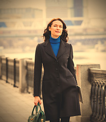 Image showing beautiful middle-aged woman in a dark coat