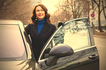 Image showing beautiful businesswoman near car