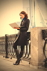 Image showing smiling middle-aged woman with a laptop