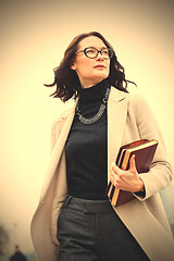 Image showing dark-haired middle-aged woman with books