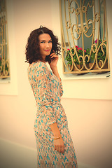 Image showing woman in a summer dress near the old window frame