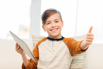 Image showing smiling boy with tablet showing thumbs up at home