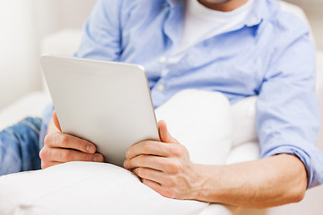 Image showing close up of man working with tablet pc at home