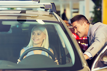 Image showing happy woman with car dealer in auto show or salon