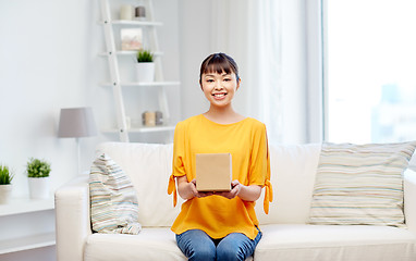 Image showing happy asian young woman with parcel box at home