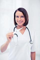 Image showing doctor with thermometer and stethoscope