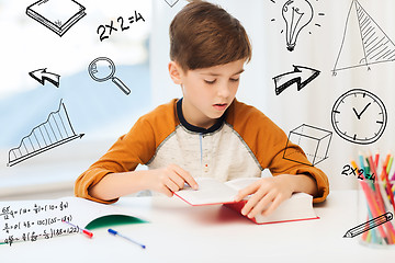 Image showing student boy reading book or textbook at home