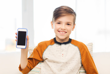 Image showing smiling boy with smartphone at home