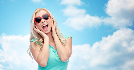 Image showing happy young woman in heart shape sunglasses