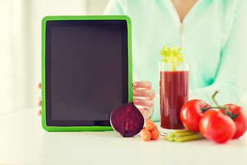 Image showing close up of woman with tablet pc and vegetables